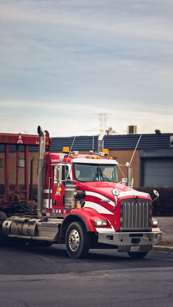 Vibrant red semi truck parked in an industrial area of Montreal, Canada.